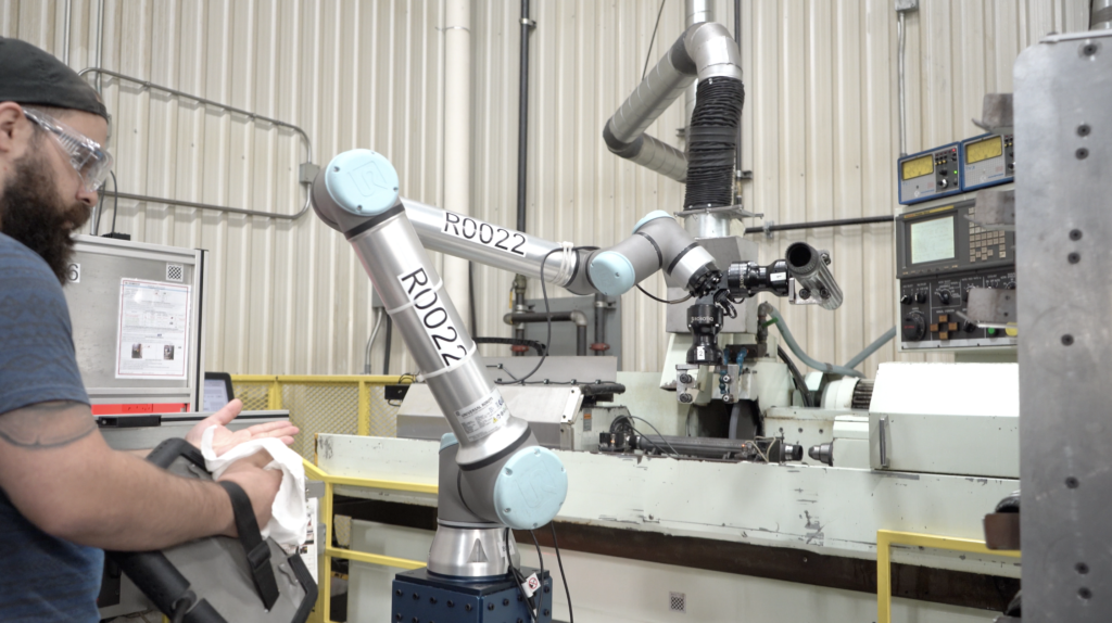 machinist using universal robots cobot collaborative robot and new robotiq machine tool tending automation solution for machining