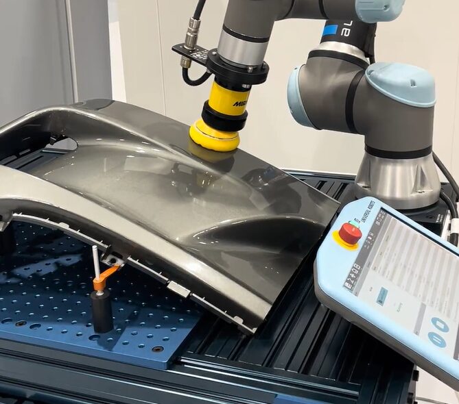 UR polishing car door, automotive industry application.